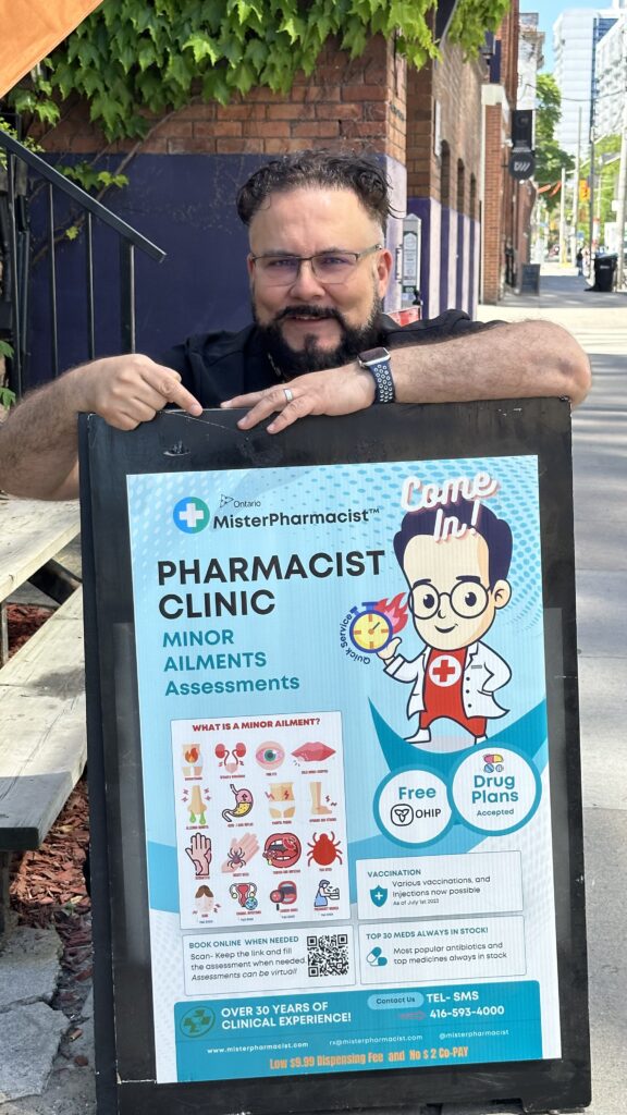 MisterPharmacist_Toronto_Online_Pharmacy A person stands outdoors in downtown Toronto, holding a sign for a pharmacy clinic offering minor ailment assessments. The sign, featuring a cartoon pharmacist, details OHIP-covered services and drug plans. In the bustling Toronto setting with brick walls and stairs, instant local deliveries are highlighted.