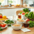 A vibrant table spread with fresh vegetables, whole grains, herbal teas, a glass of water, and a notepad with digestive health tips in a bright kit...