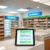 Modern pharmacy counter with digital tablet showing medication reminders and health tips in a bright, welcoming space.