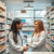 Bright pharmacy interior with a pharmacist consulting a smiling patient, surrounded by shelves of medications and health products.