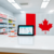 Modern pharmacy counter with medication bottles, digital tablet showing healthcare info, and a subtle Canadian flag backdrop symbolizing Ontario he...