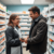Modern pharmacy interior with a pharmacist consulting a patient, shelves stocked with prescription medications and antibiotics, symbolizing accessi...