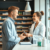 Modern pharmacy interior with pharmacist consulting a patient, shelves stocked with medication and health products, highlighting accessible healthc...